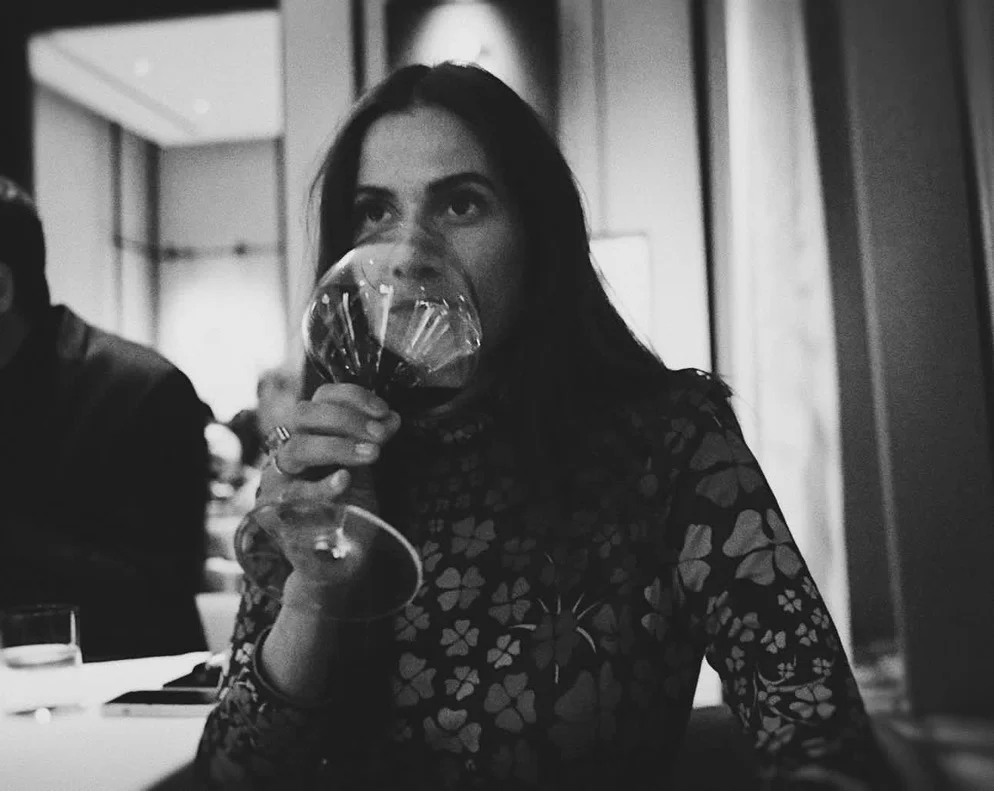 Black-and-white photo of Sahra-Josephine with a glass of wine