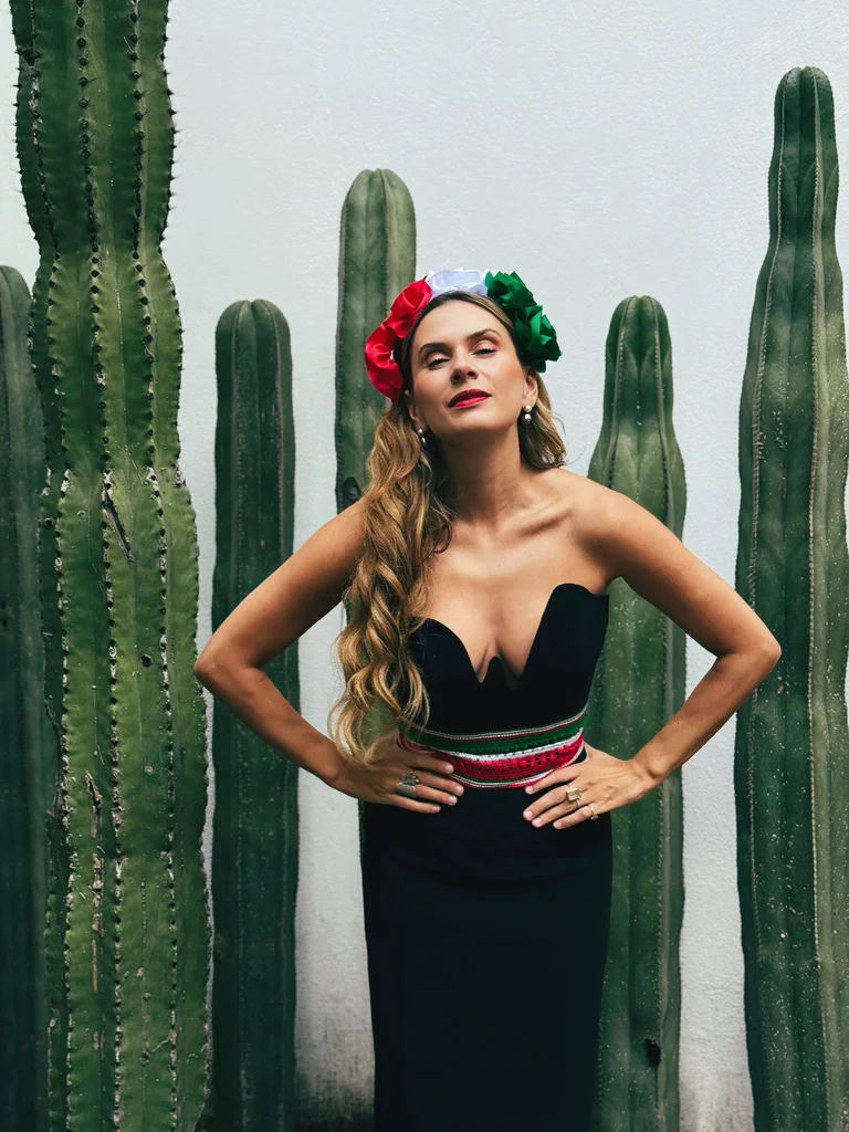 Sahra-Josephine with hands on hips among cacti