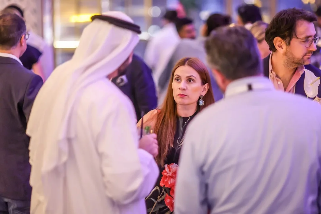 Sahra-Josephine in conversation at an evening reception