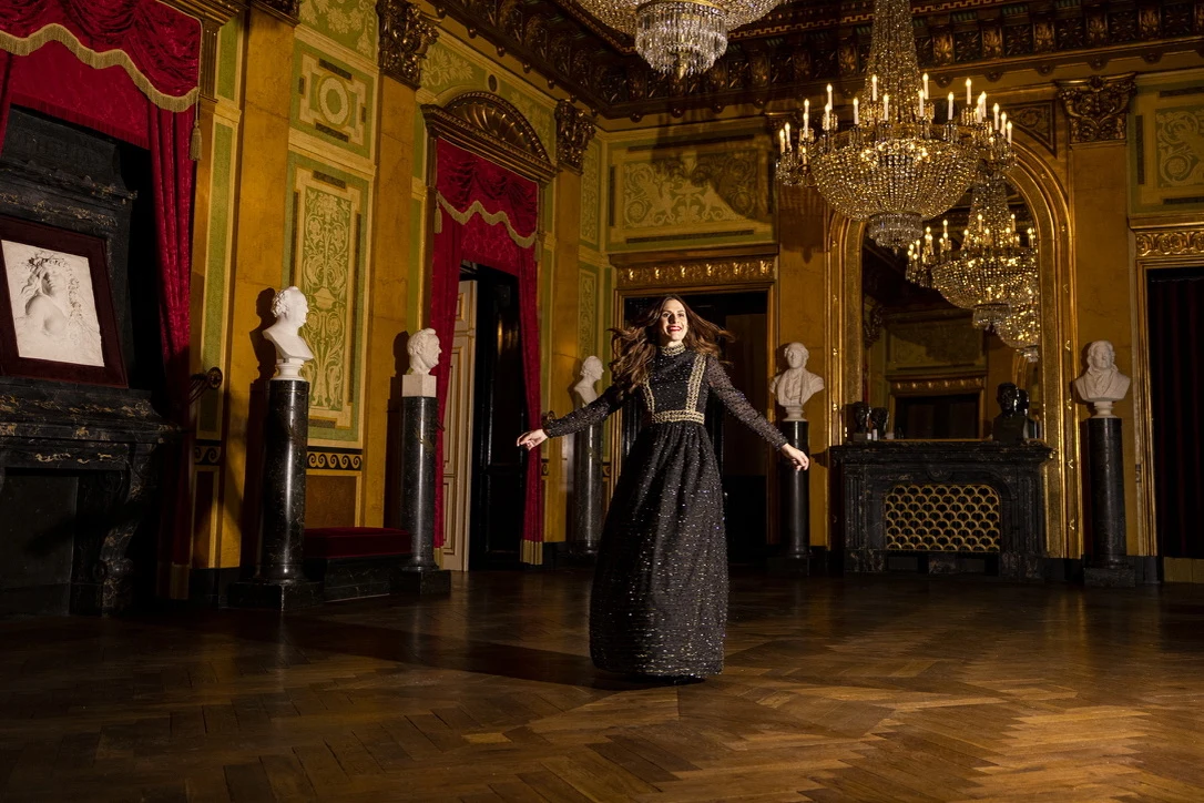 Sahra-Josephine in a chandelier-lit ballroom