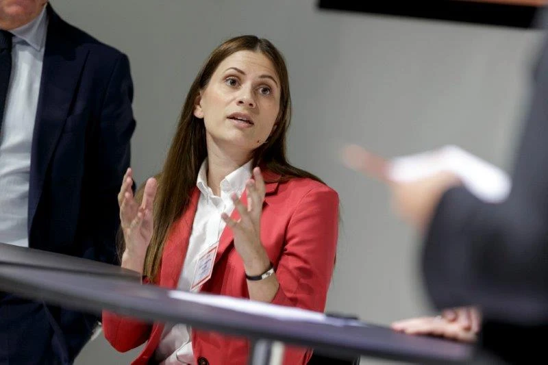 Sahra-Josephine speaking in a red suit