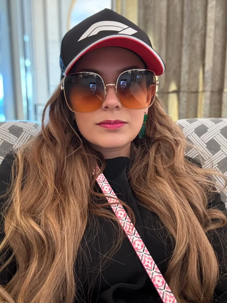 Sahra-Josephine in a racing cap and sunglasses